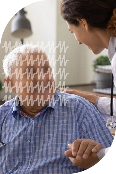 Elderly man holding hands with a doctor, smiling warmly.
