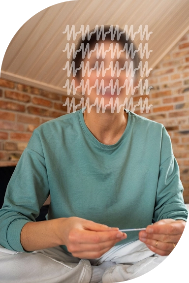 Woman holding a medical monitoring kit, examining it closely.