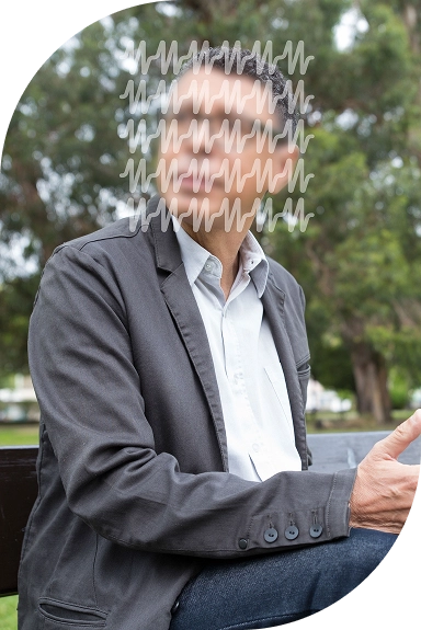 Man sitting on a park bench, relaxing.