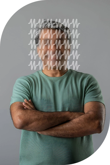 Middle-aged man with crossed arms, smiling confidently.