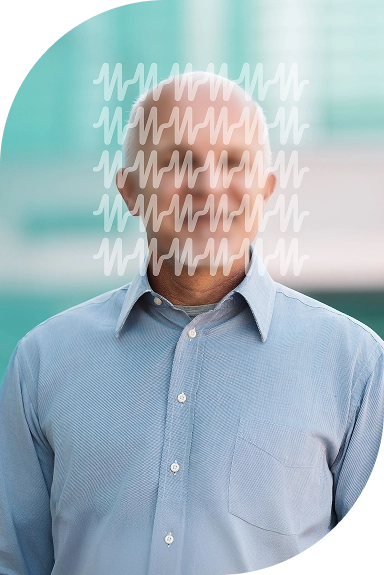 Elderly man standing and smiling warmly