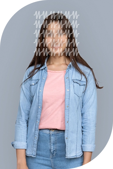 A woman standing and smiling warmly.