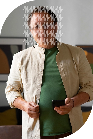 A man standing and holding a mobile phone.